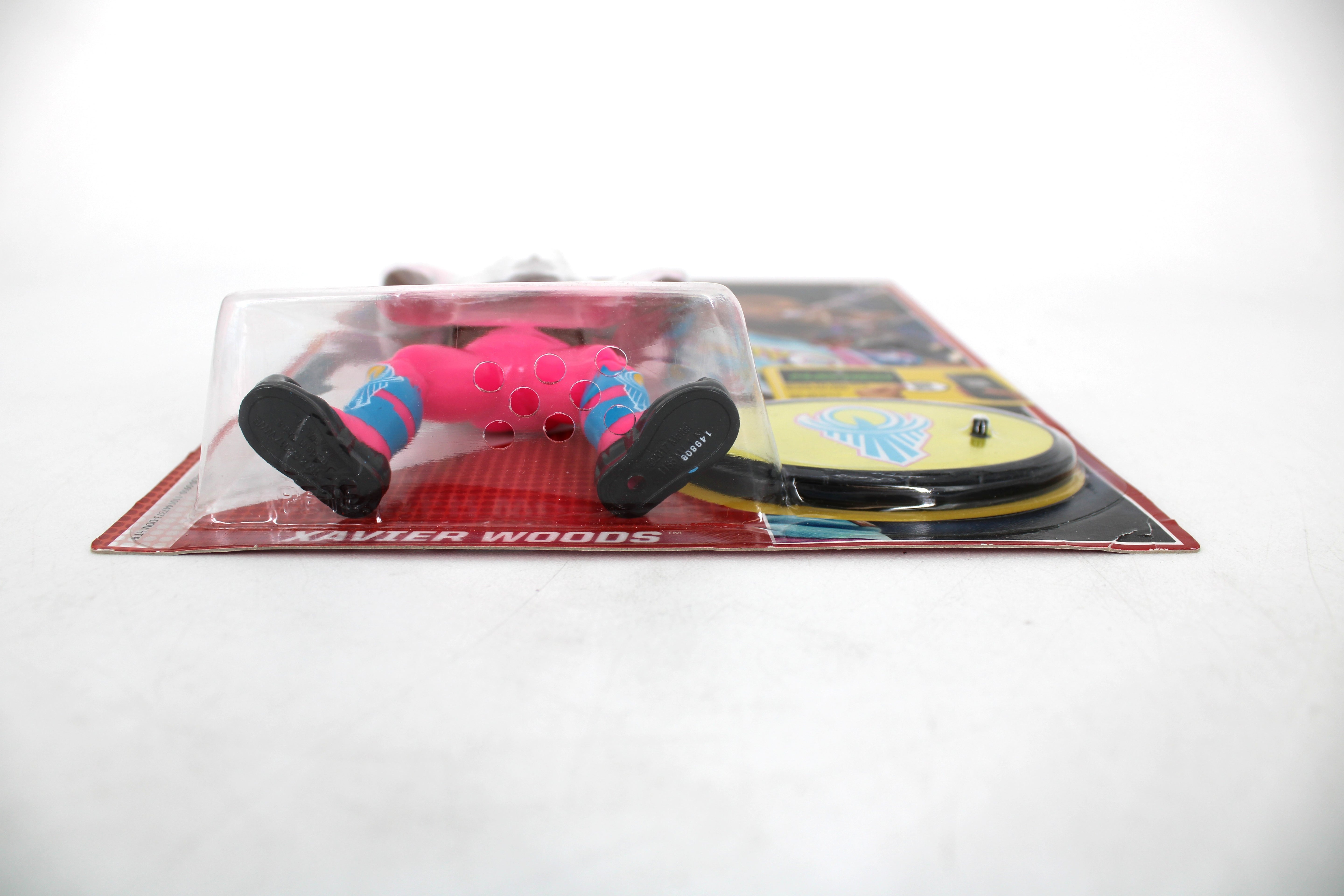 Xavier Woods WWE Retro App Series Action Figure — Side View Showing Figure in Bubble with Xavier Woods Name Label and New Day Accessory