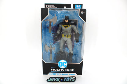 Batman Battle Damage DC Multiverse 7-Inch Figure — Card Front with Grey and Yellow Costume Visible Through Window