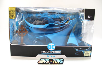 Batman Year Two DC Multiverse Gold Label Figure — Box Front View with Dramatic Plastic Cape and Graveyard Cross Visible