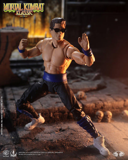 Johnny Cage Mortal Kombat Klassic 7-Inch Figure — Front View with Mortal Kombat Klassic Logo Overhead in Arena Setting