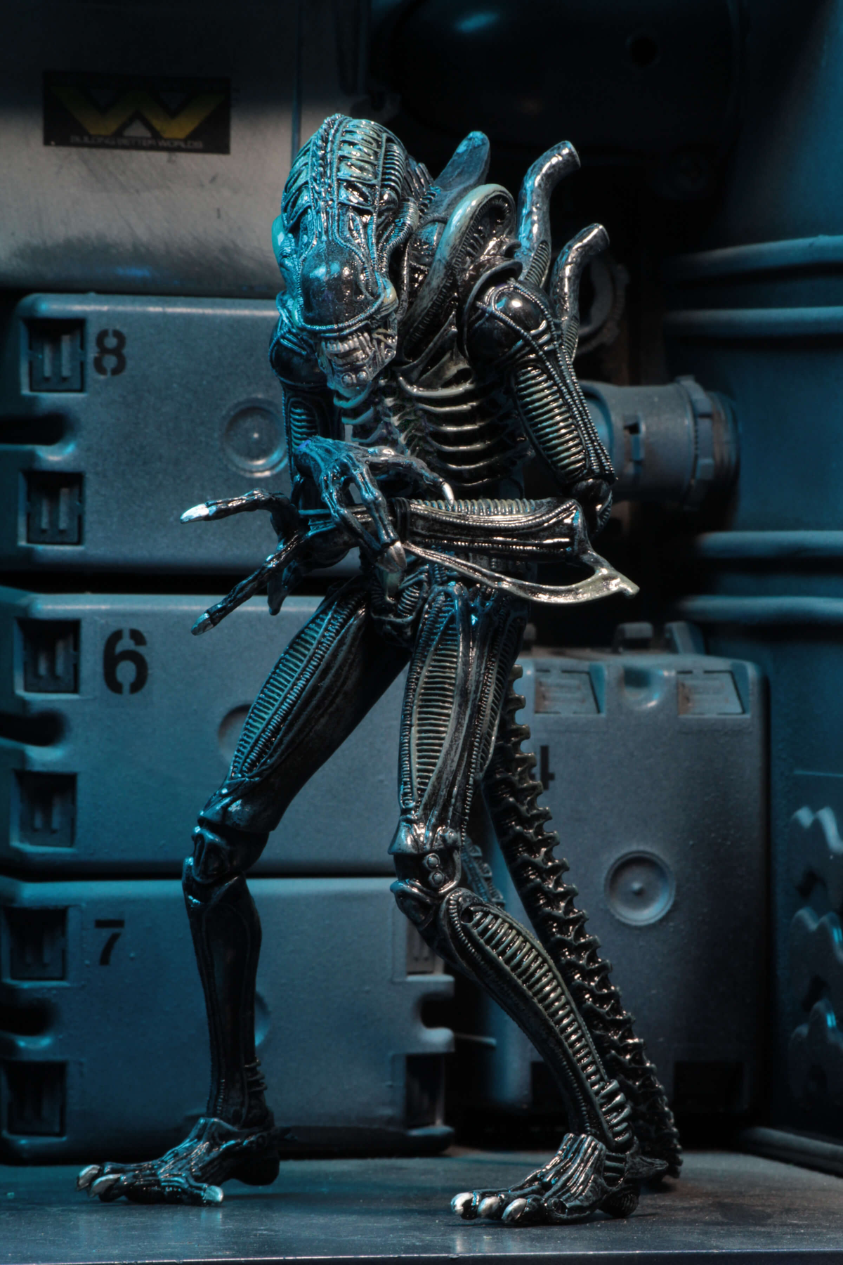 Aliens Ultimate Blue Warrior NECA 9-Inch Figure — Side View in Crouching Pose Against Sci-Fi Backdrop