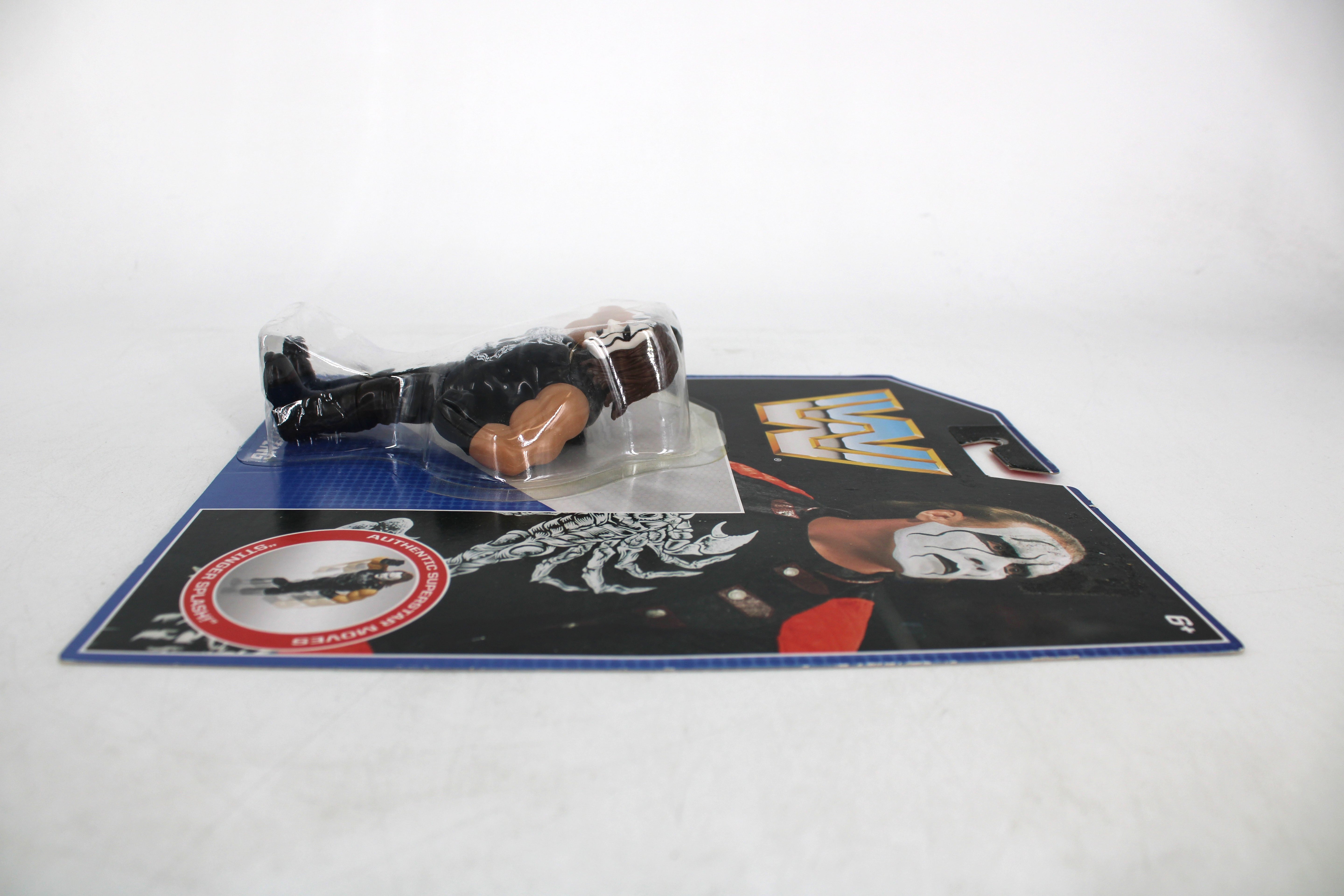 Sting WWE Retro Action Figure — Side View with Card Art Showing Sting Portrait and WWE Logo