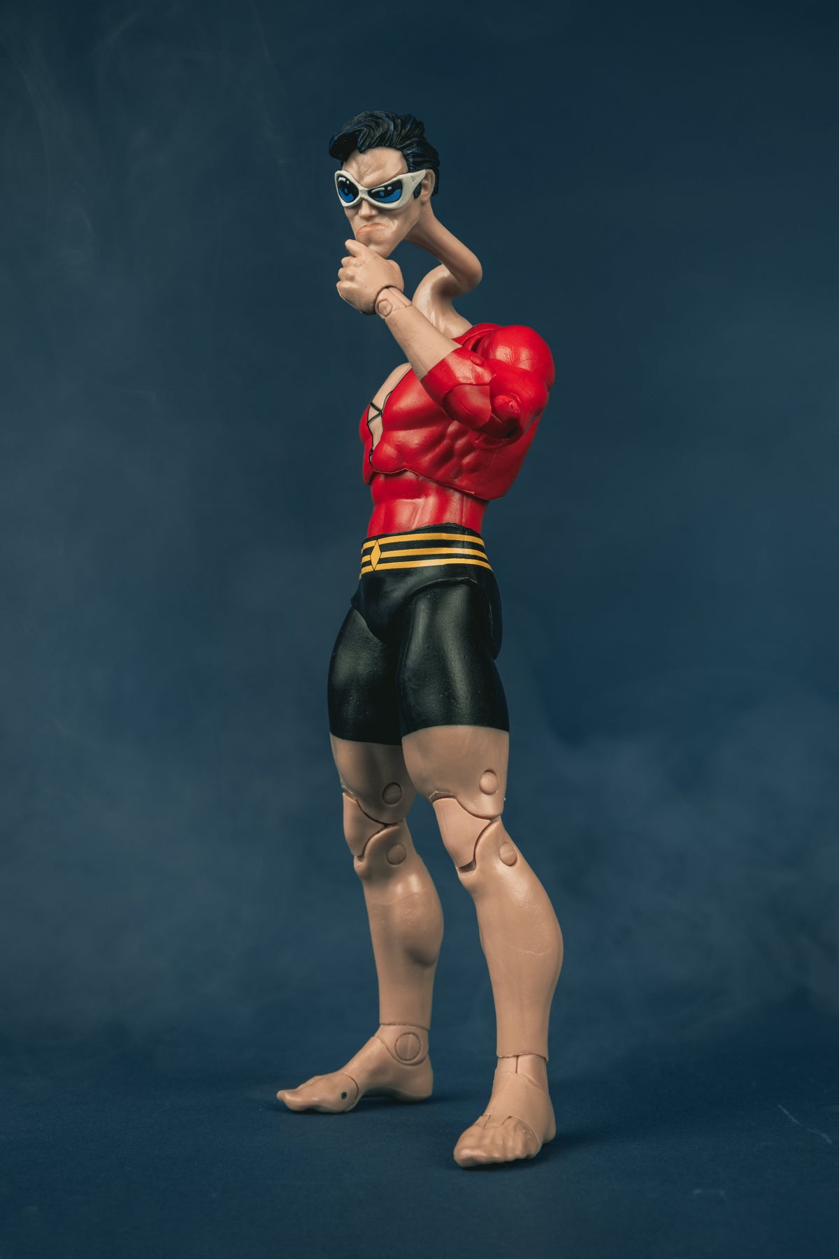 Plastic Man DC Multiverse 7-Inch Figure — Side View with Stretched Neck and Fist Raised