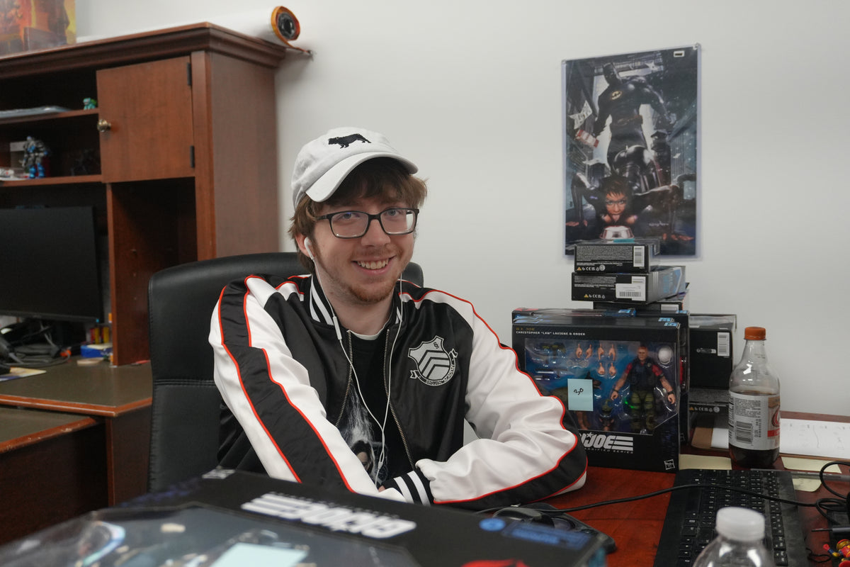 Alex, Listing Specialist at Jay’s Toys & Games, at his desk beside a stack of G.I. Joe Classified figures