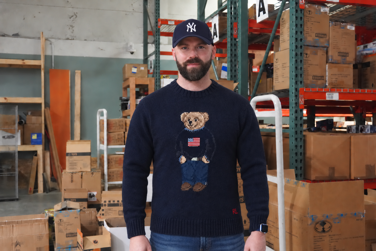 Jordan, Head of eCommerce and Operations at Jay’s Toys & Games, standing in the warehouse aisle in front of the racking