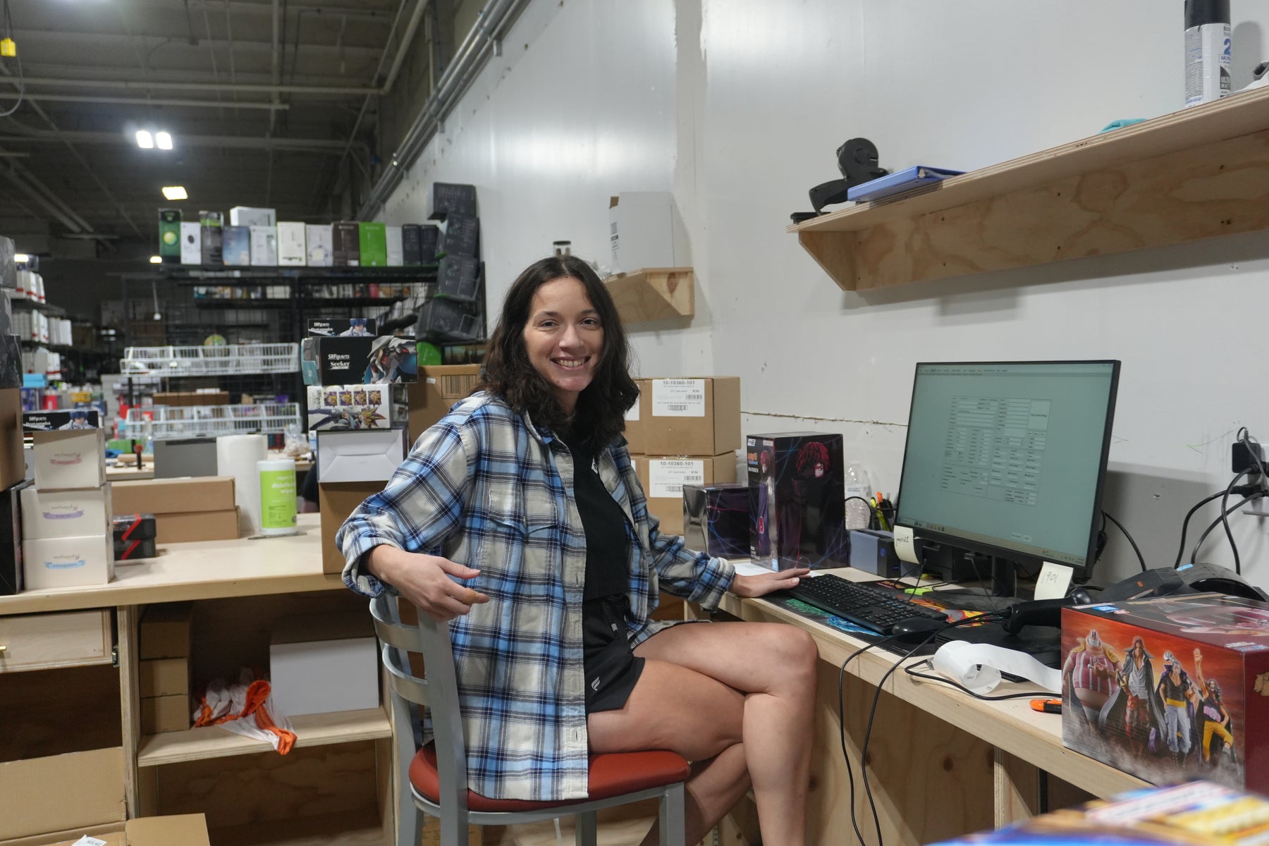Kylee, Finance and Receiving Manager at Jay’s Toys & Games, at her desk in the warehouse
