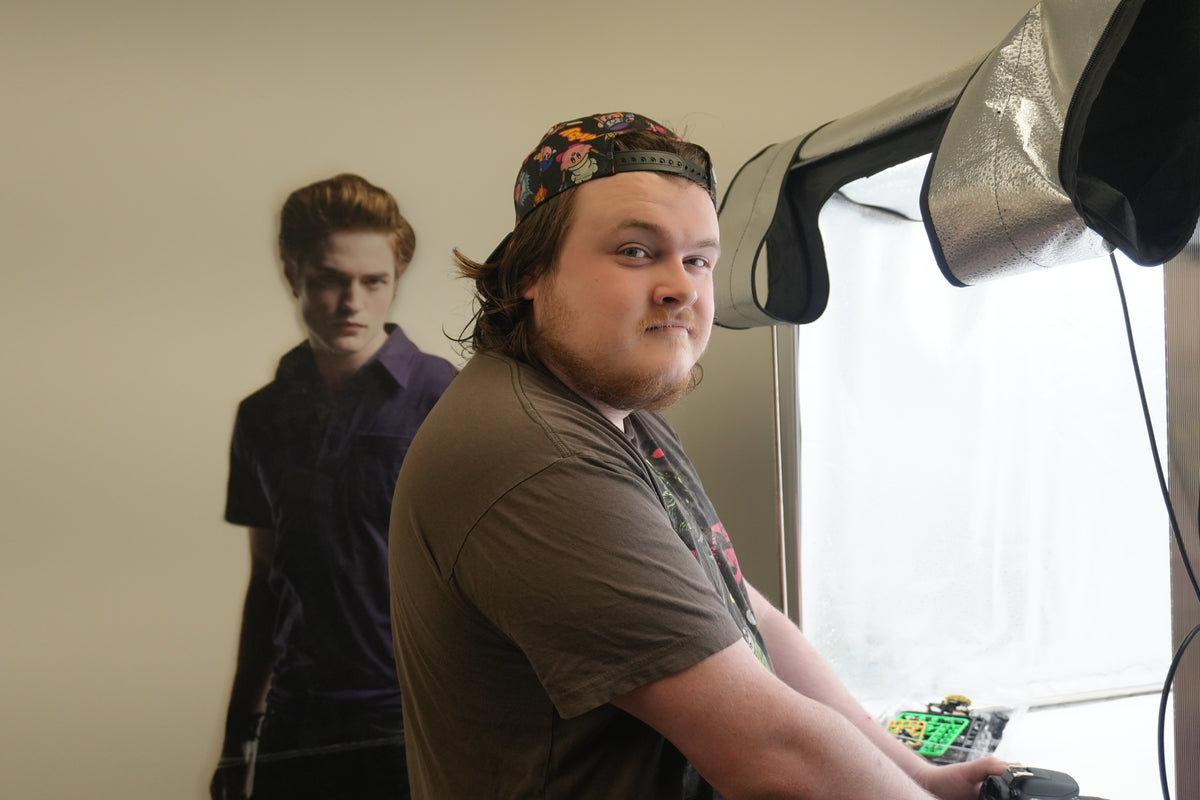 Slade, Listing Specialist at Jay’s Toys & Games, at the photo booth with an Edward Cullen cut-out behind him